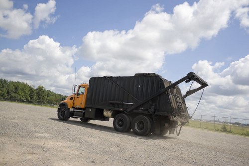 Workers wearing PPE while loading waste