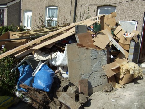Mini skip placed in a backyard for small-scale waste disposal